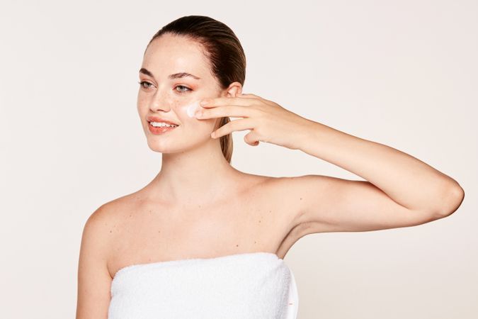 Amiable female taking care of face