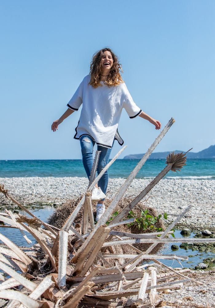 Young woman walking near dried plants