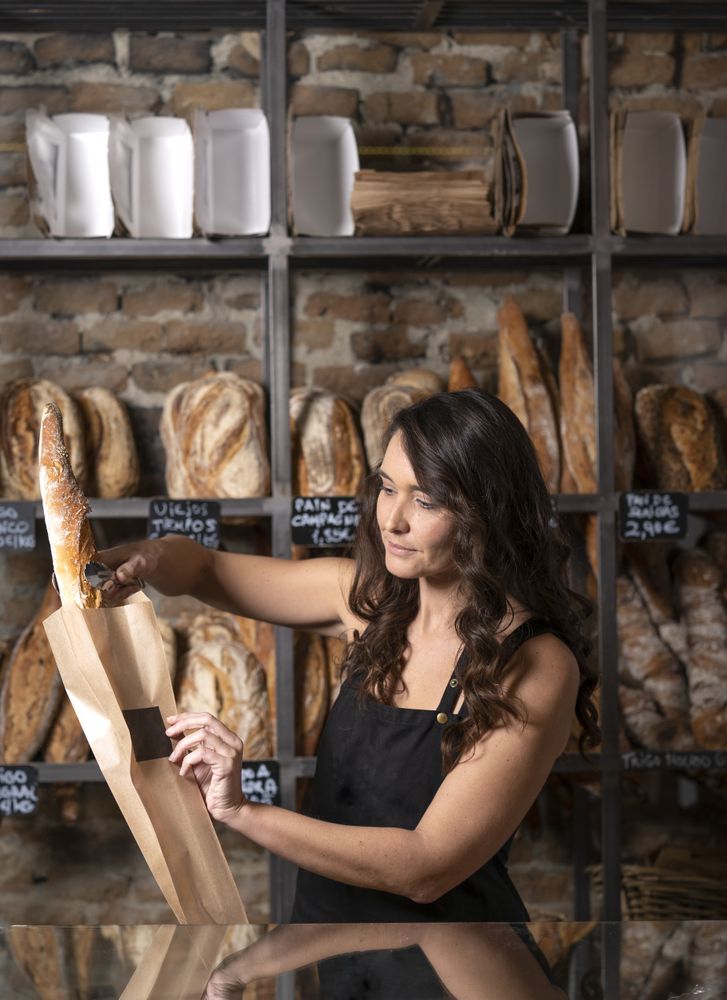 Young female selling baguettes