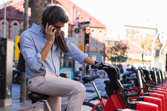 Man talking on smartphone on electric scooter