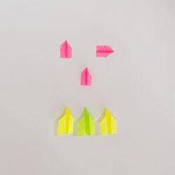 Flat lay of colorful paper airplanes