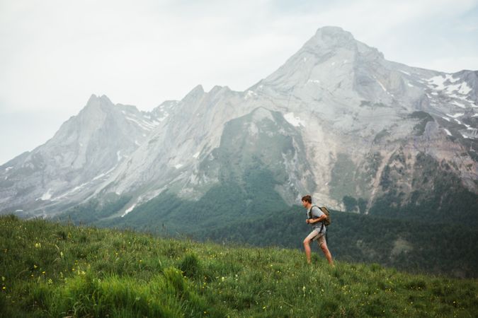 Unrecognizable man with backpack hiking in Pyrenees mountains