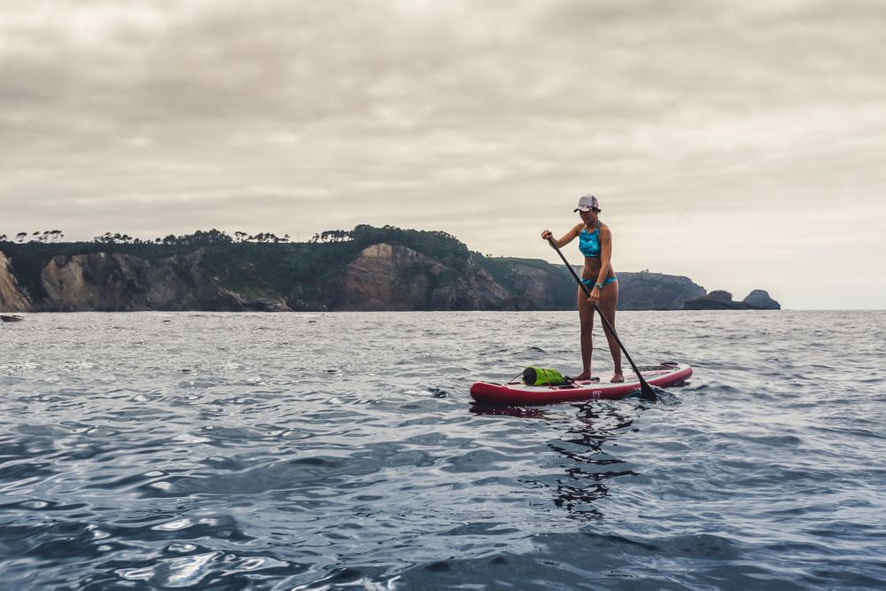 Woman on paddleboard floating in sea