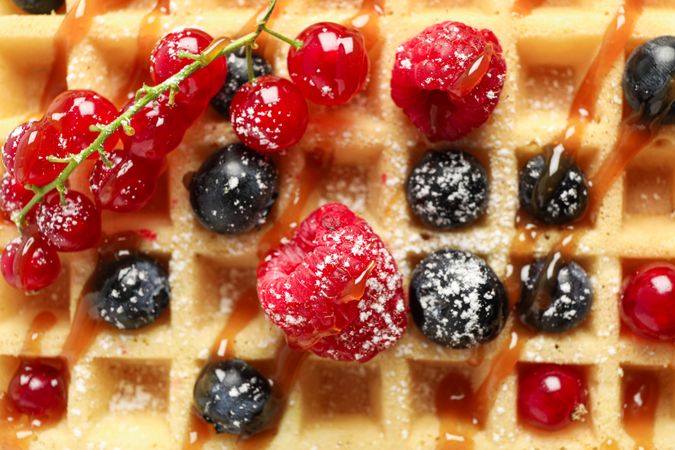 Waffle with fruits and powdered sugar as background