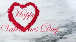 Red outline of heart for Valentine’s day holiday on marble stone with text message