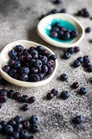 Close up of two small bowls of blueberries