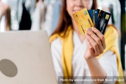 Happy woman showing credit card for online shopping 0Pwneb