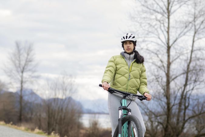 Young female on a bicycle looking at camera