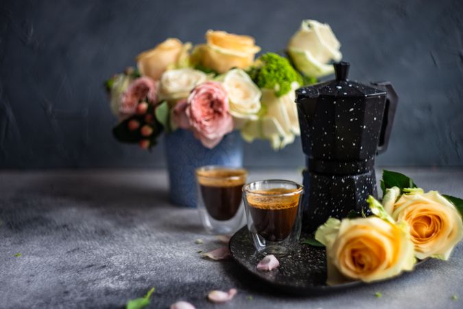 Two espressos with bouquet of roses and moka with copy space