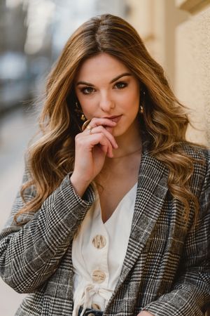 Woman leaning on wall on street