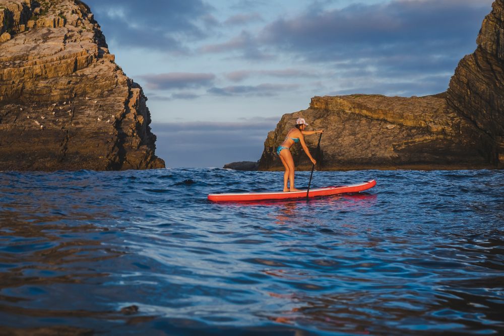 Woman on paddleboard floating in sea