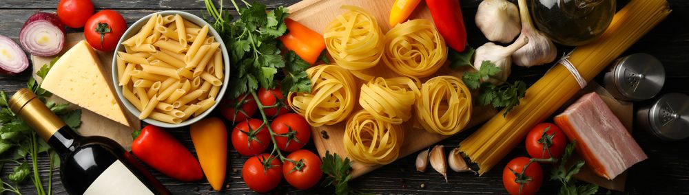Composition with pasta and ingredients for cooking on wooden background, top view
