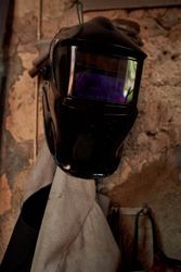 Mask of welder hanging on wall