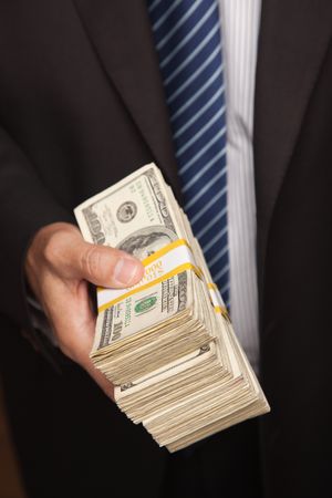 Businessman Handing Over Stack of Cash