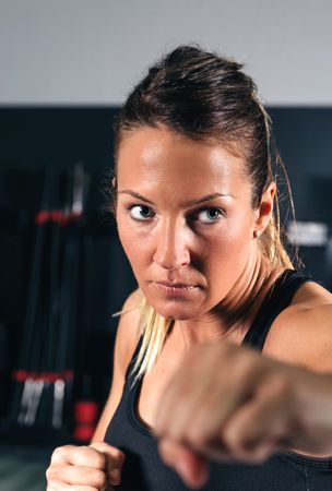 Portrait of woman doing boxing training in fitness class
