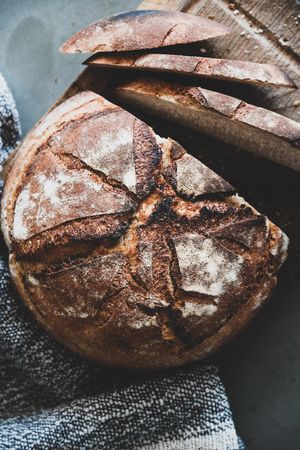 Freshly baked sourdough bread loaf, sliced, vertical composition, close up