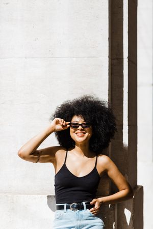 Cheerful female in dark sunglasses