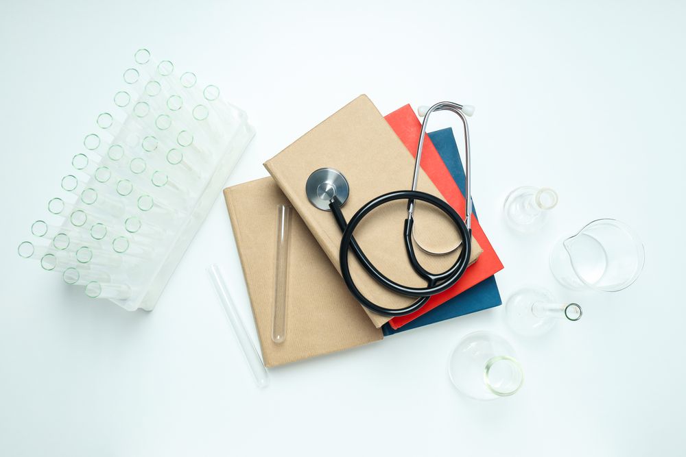 Concept of medical education and books, top view