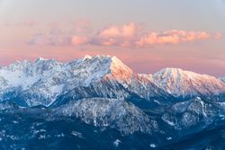 Snow covered mountain under cloudy sky