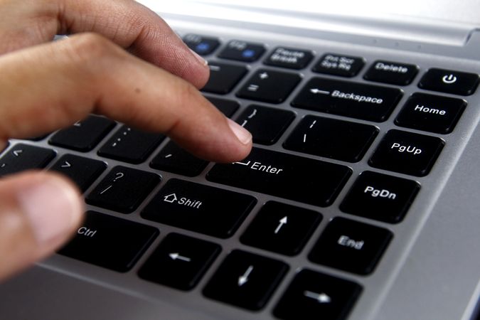 Person using laptop keyboard