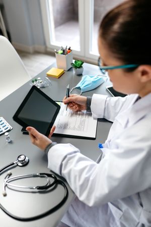 Female doctor using tablet while working