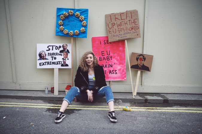 London, England, United Kingdom - March 23rd, 2019: Woman sitting with pro-EU political signs