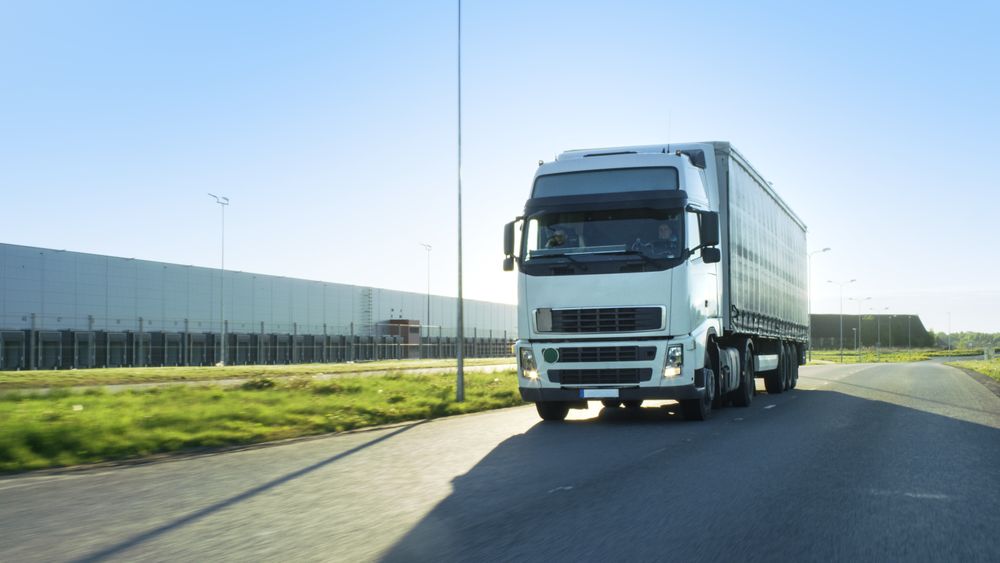 Front-View of Semi Truck with Cargo Trailer Driving on a Highway.