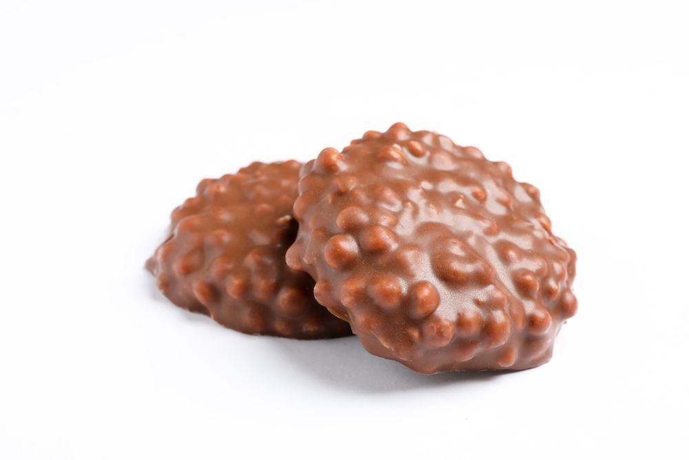 Chocolate cookies with caramel filling on plain background