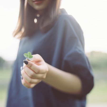 Woman holding green leaf
