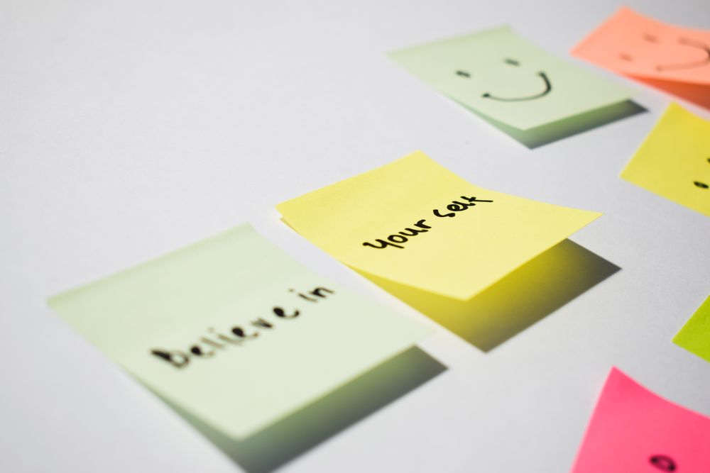 Believe in yourself and smile emoticon on sticky notes