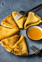 Plate of pancakes with honey