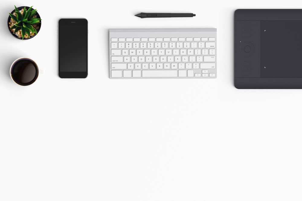Modern workspace with coffee cup, smartphone, paper, notebook and tablet copy space