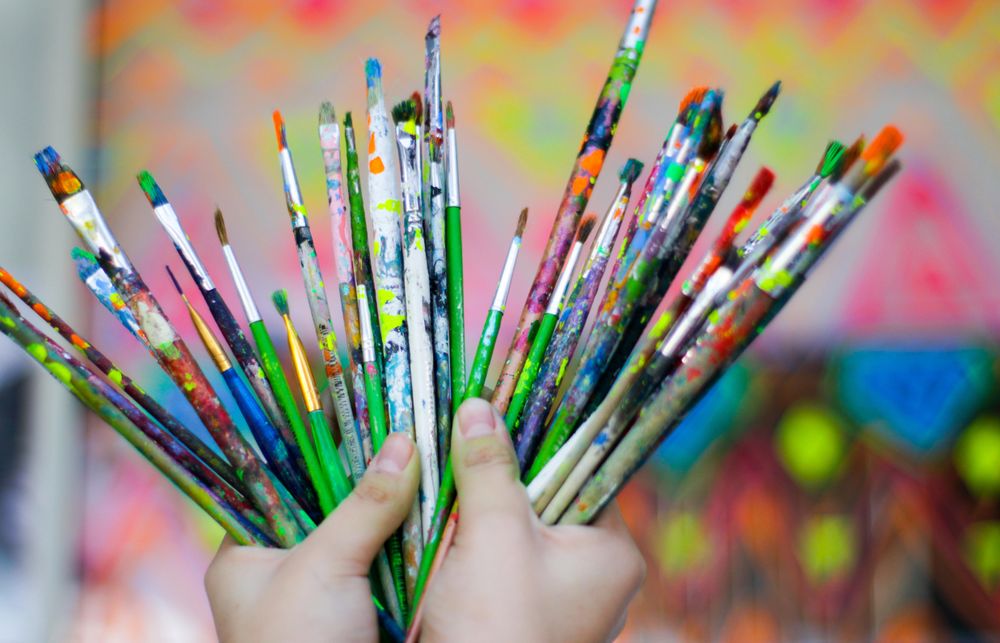 Person holding paint brush