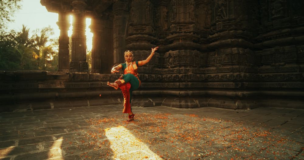 Portrait of Indian Woman in Traditional Clothes Dancing Bharatanatyam in Colourful Sari While Looking at the Camera.