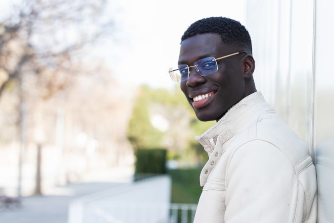 Stylish Black businessman in eyeglasses in town