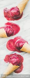 Four cones of dark berry ice cream melting on marble slab, vertical composition 4mgoe0