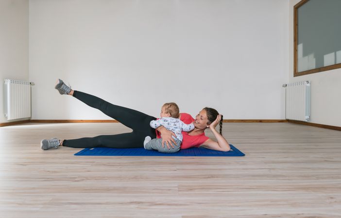 Mother exercising with baby in gym