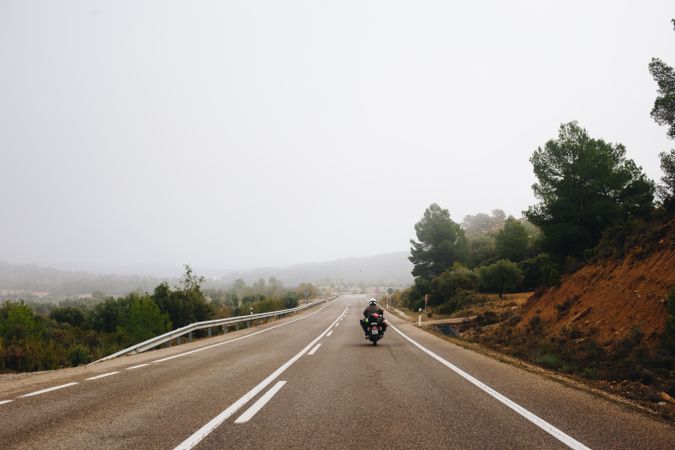 Motorcyclist riding on a foggy day