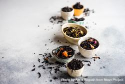 Bowls of loose leaf tea on marble counter 0LlqX0