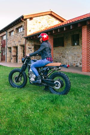 Woman with helmet riding custom motorbike
