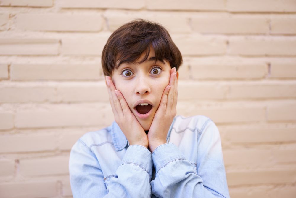 A Surprised Young Girl Expressing Her Excitement with Genuine Emotion and Enthusiasm