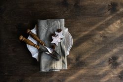Top view of table setting with Christmas star ornaments on wooden table