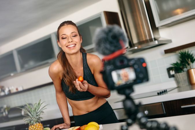 Lean female making healthy recipe for youtube channel