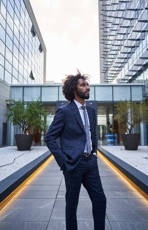 Confident businessman standing on downtown street