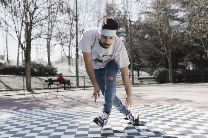 Man dancing break dance in park