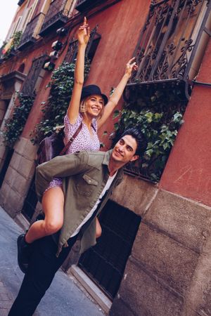 Happy couple having fun while walking in town