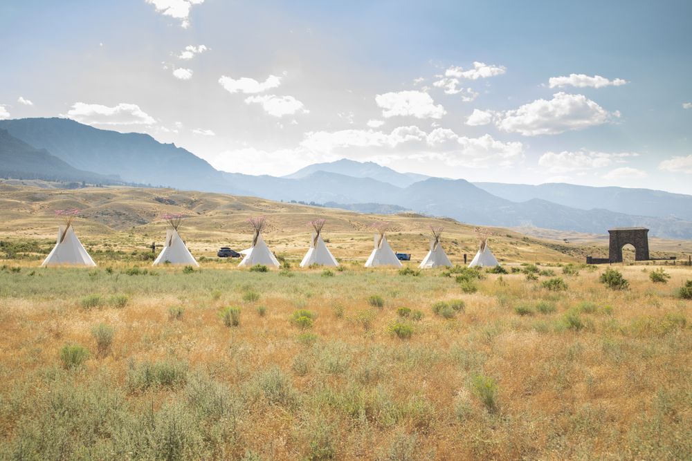 Montana, United States - August 17, 2022: Teepees in front of mountains in Yellowstone National Park