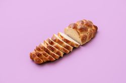 Challah bread isolated on purple background