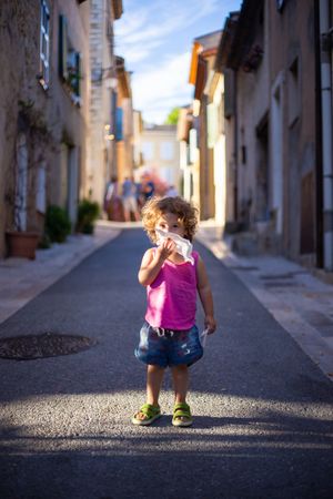 Smiling child standing on street