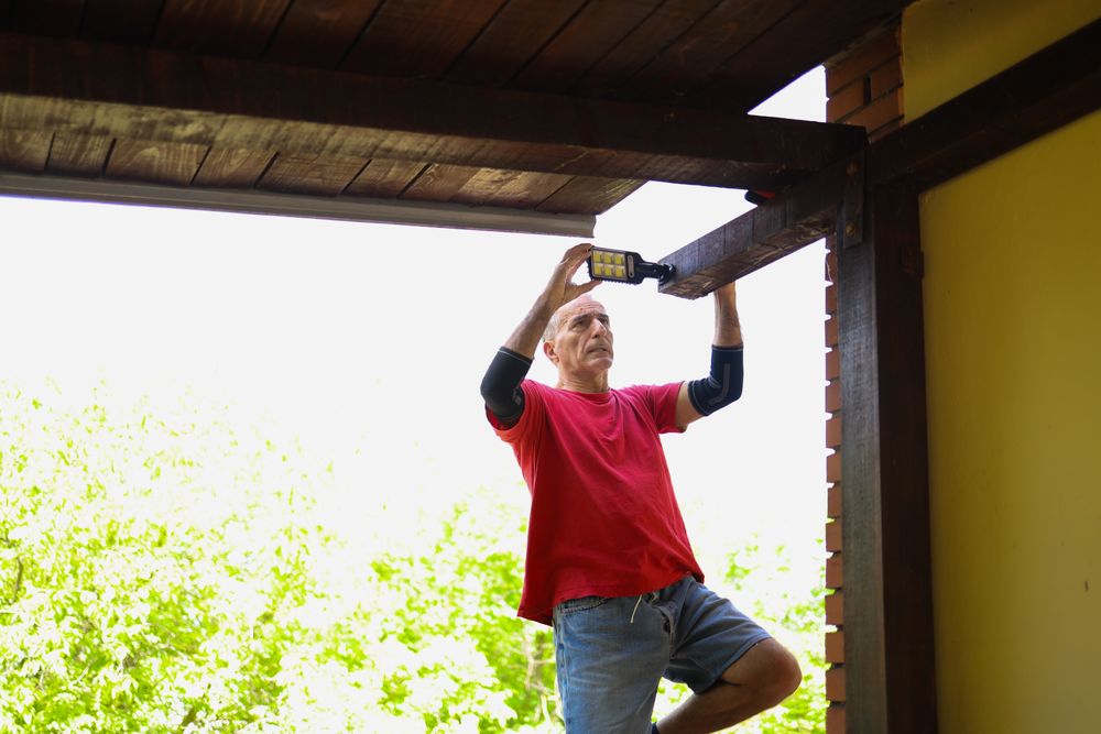 Focused Carpentry: Man Balancing While Drilling Wooden Beam Outdoors